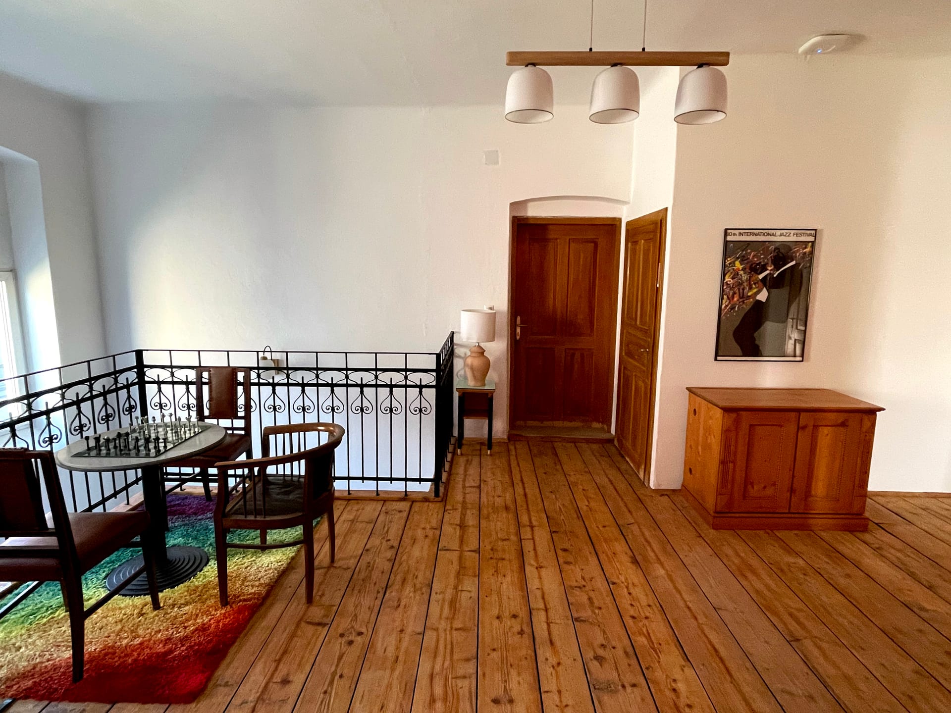 Galerie im Obergeschoss mit Schachtisch und schmiedeeisernem Geländer
